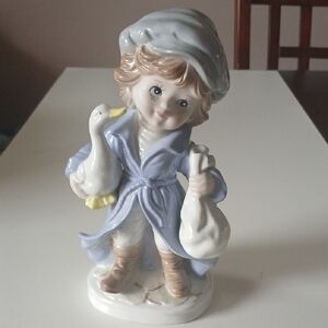 Vintage Porcelain Figurine Young Boy with Frecled Face Holding a Goose and a Sac